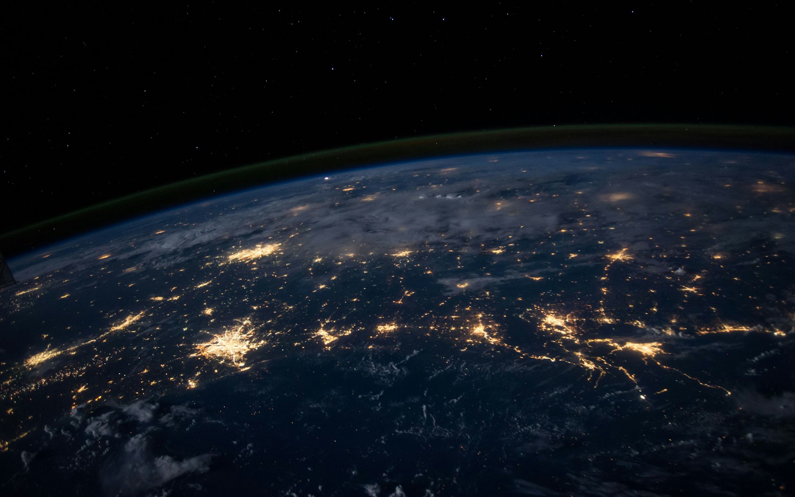 Earth at night showing city lights across delivery regions